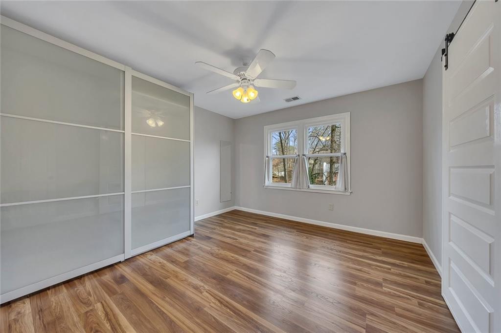 507 Spring Creek Way Northeast Marietta, GA 30068 - Photo 31 of 50 wooden floor in an empty room with a window