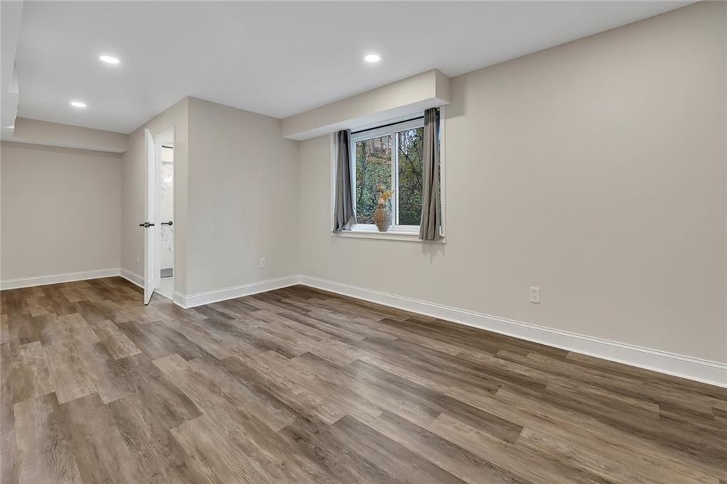 507 Spring Creek Way Northeast Marietta, GA 30068 - Photo 32 of 50 a view of empty room with wooden floor and fan