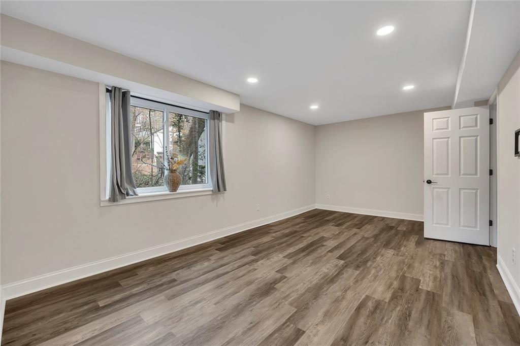 507 Spring Creek Way Northeast Marietta, GA 30068 - Photo 35 of 50 a view of empty room with wooden floor and fan