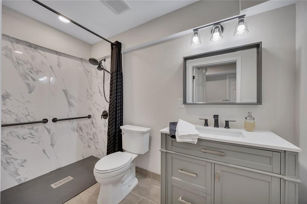 507 Spring Creek Way Northeast Marietta, GA 30068 - Photo 36 of 50 a bathroom with a toilet sink and mirror