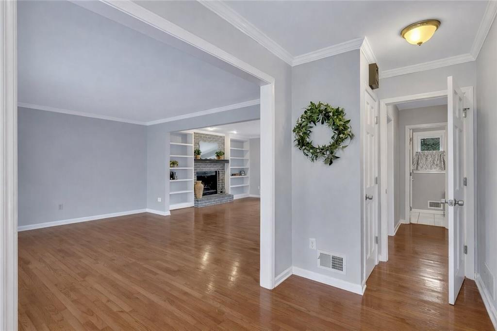 507 Spring Creek Way Northeast Marietta, GA 30068 - Photo 7 of 50 a view of a hallway with wooden floor and a living room