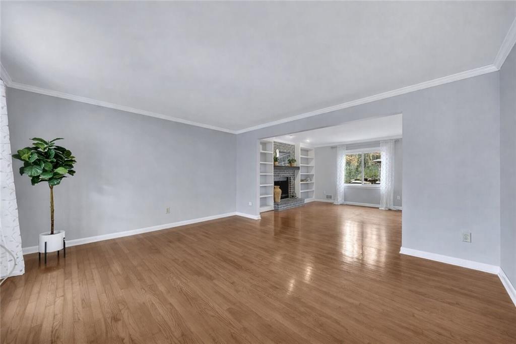 507 Spring Creek Way Northeast Marietta, GA 30068 - Photo 8 of 50 a view of empty room with wooden floor and potted plant
