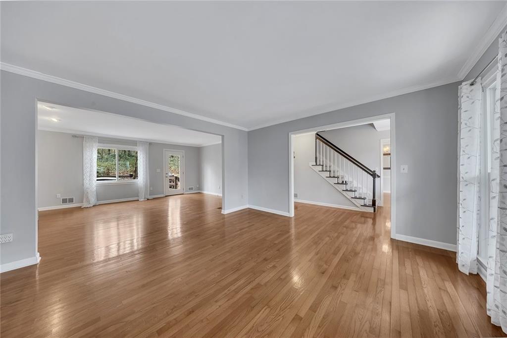507 Spring Creek Way Northeast Marietta, GA 30068 - Photo 9 of 50 a view of empty room with wooden floor and window
