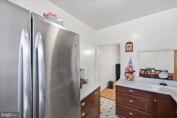 a hallway with mirror and cabinets