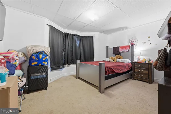 a bedroom with a bed and a tv