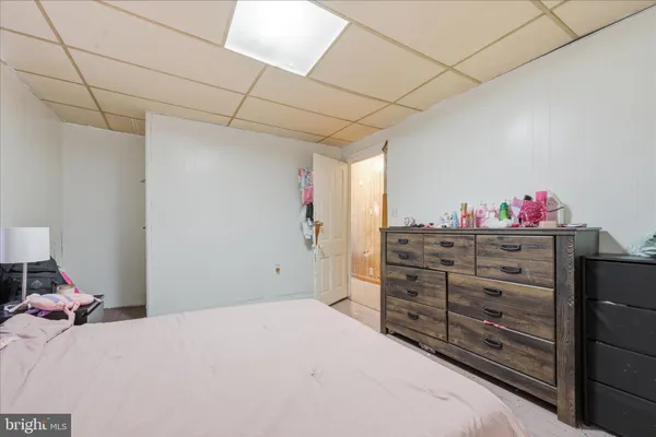 a bed room with a bed and a dresser