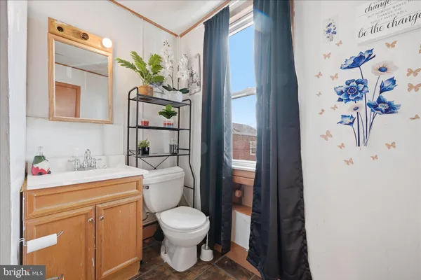 a white toilet sitting next to a bathroom sink