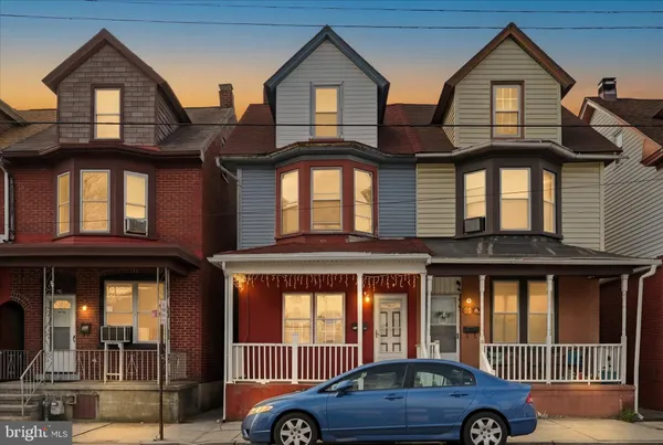 a front view of a house with parking space