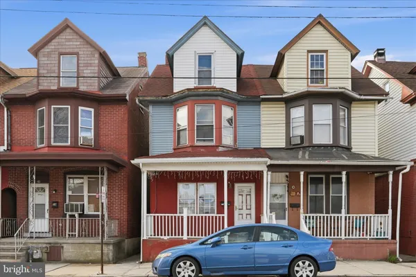 a front view of a house with parking space