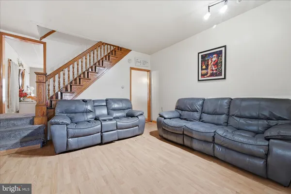 a living room with furniture and stairs