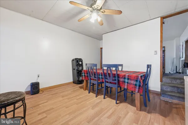 a dining room with furniture and wooden floor