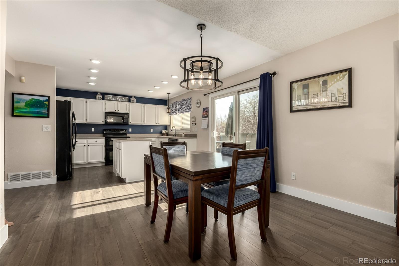 8894 Miners Street Highlands Ranch, CO 80126 - Photo 11 of 41 a view of a dining room with furniture window and wooden floor