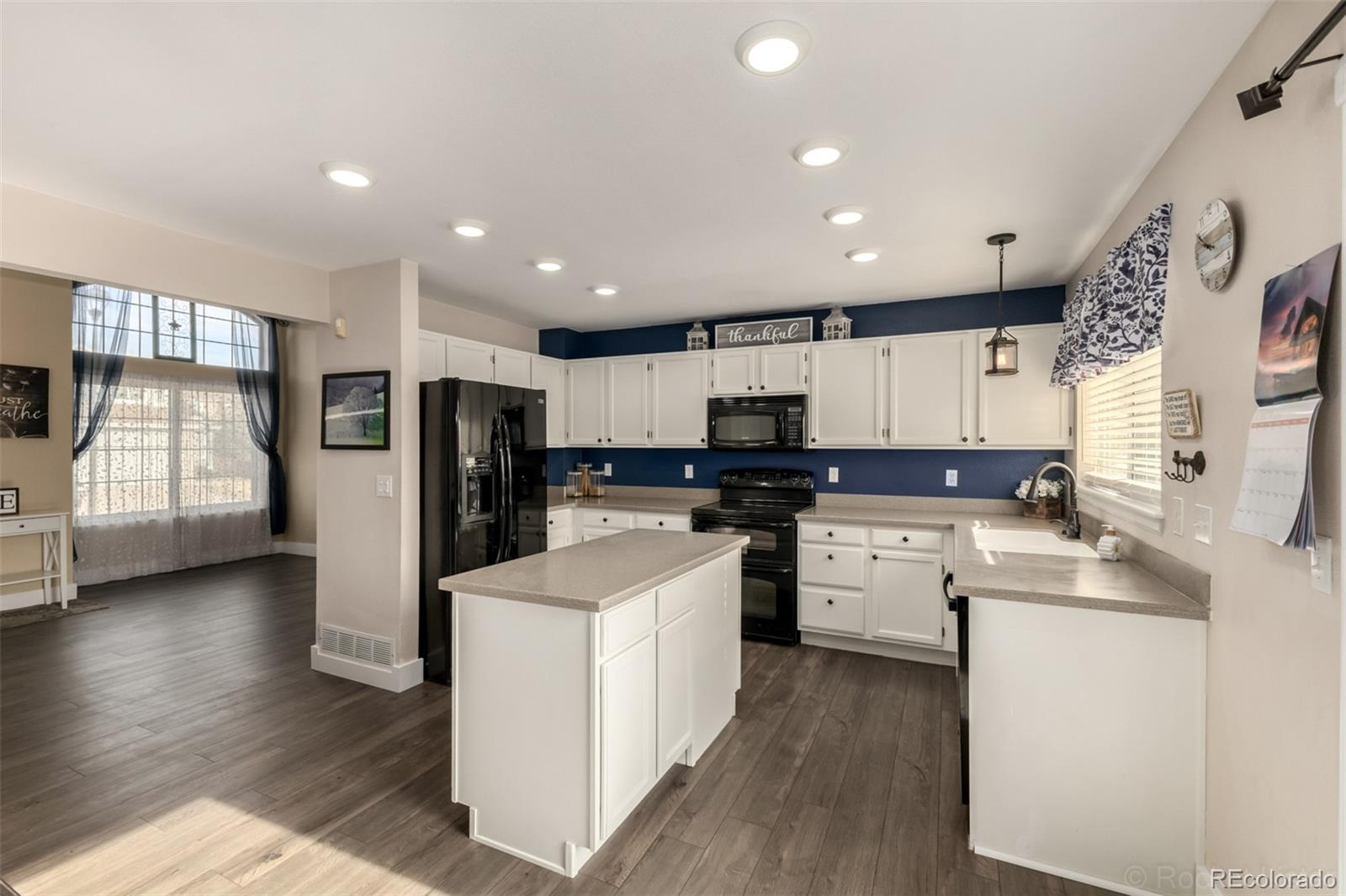 8894 Miners Street Highlands Ranch, CO 80126 - Photo 12 of 41 a kitchen with refrigerator and cabinets