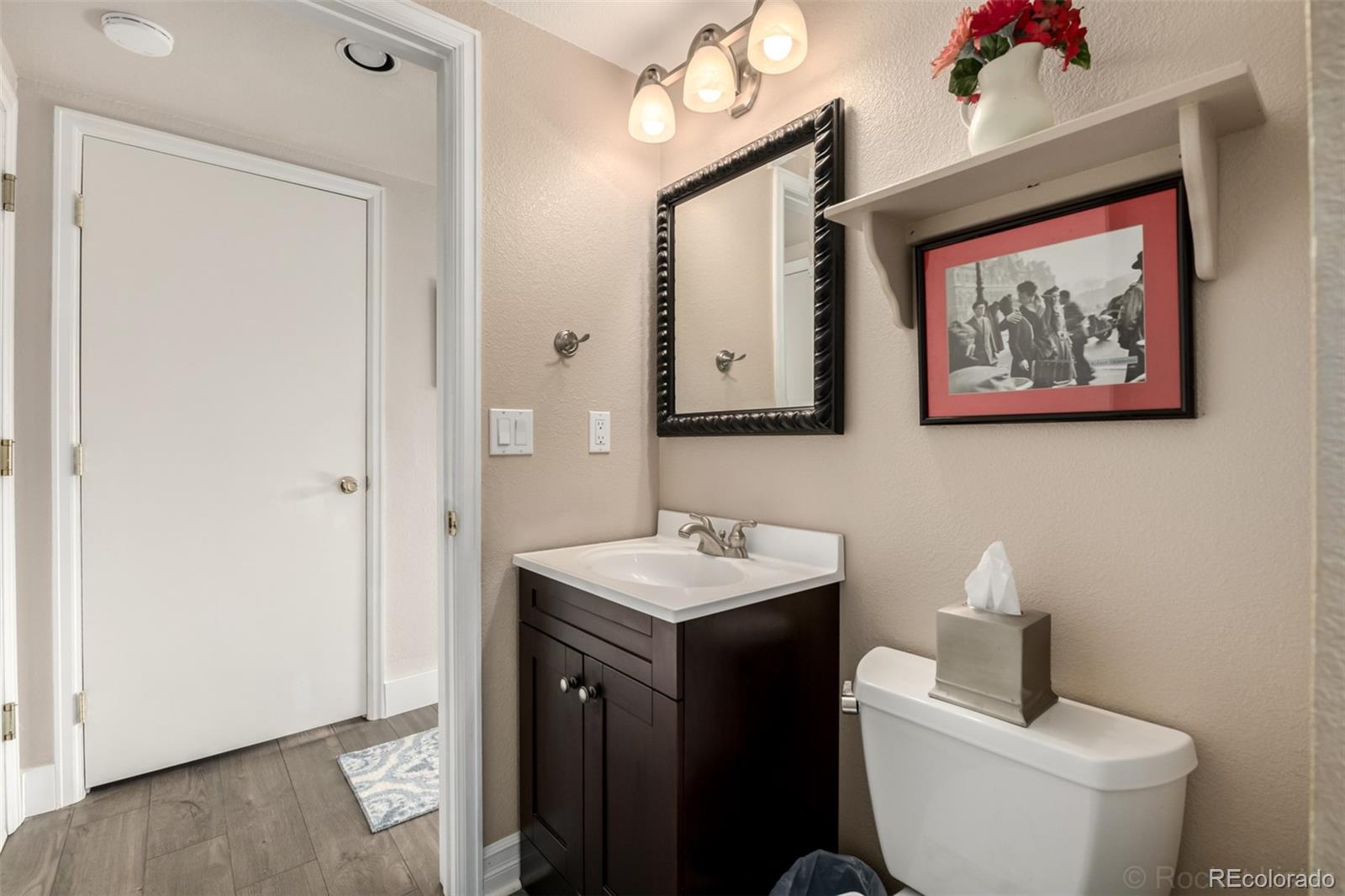 8894 Miners Street Highlands Ranch, CO 80126 - Photo 16 of 41 a bathroom with a toilet sink and mirror