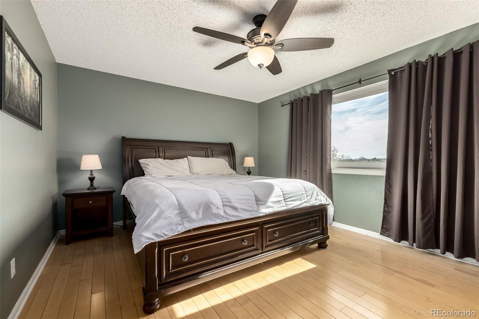 8894 Miners Street Highlands Ranch, CO 80126 - Photo 17 of 41 a bedroom with a bed dresser and a window