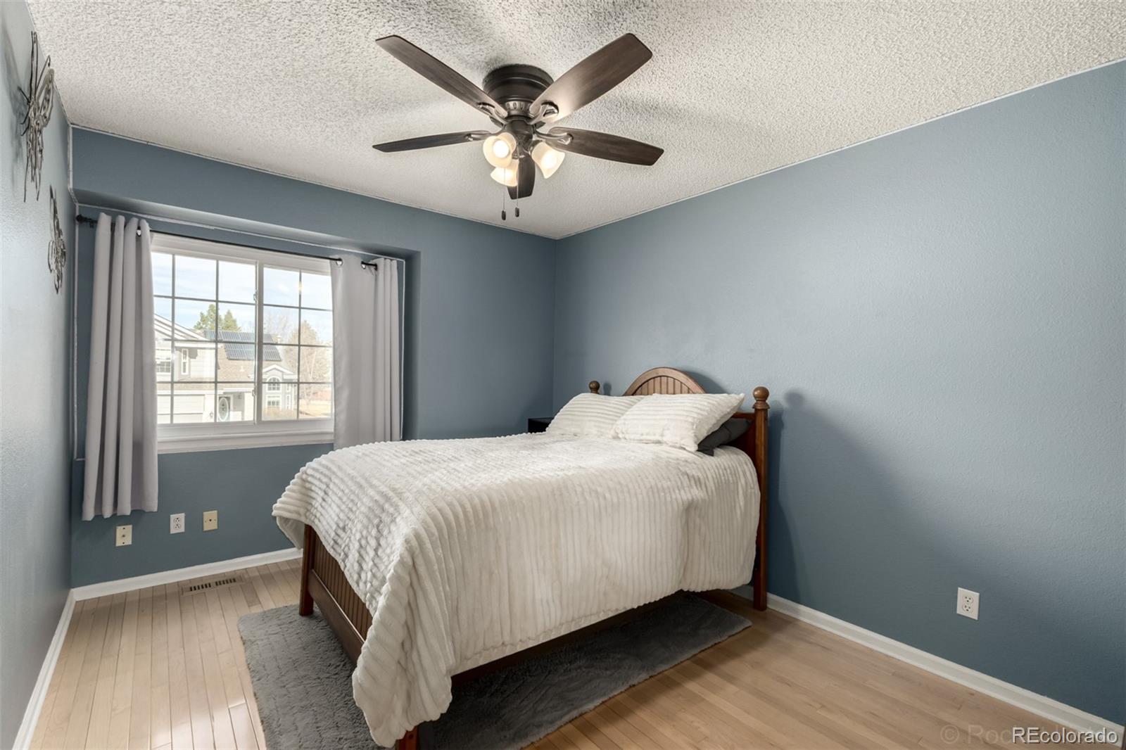8894 Miners Street Highlands Ranch, CO 80126 - Photo 22 of 41 a bed sitting in a bedroom next to a window