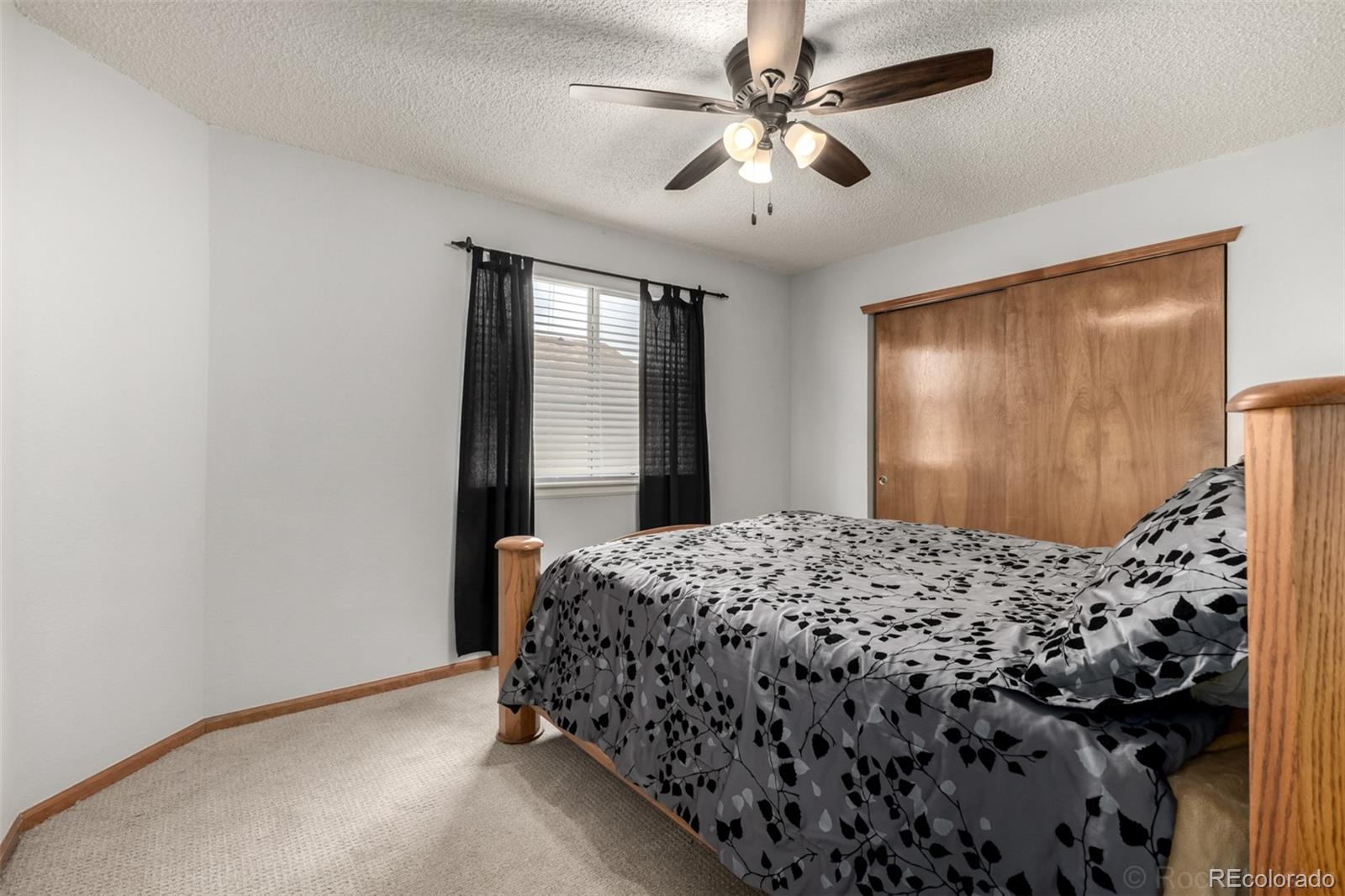 8894 Miners Street Highlands Ranch, CO 80126 - Photo 23 of 41 a bedroom with a bed and a window