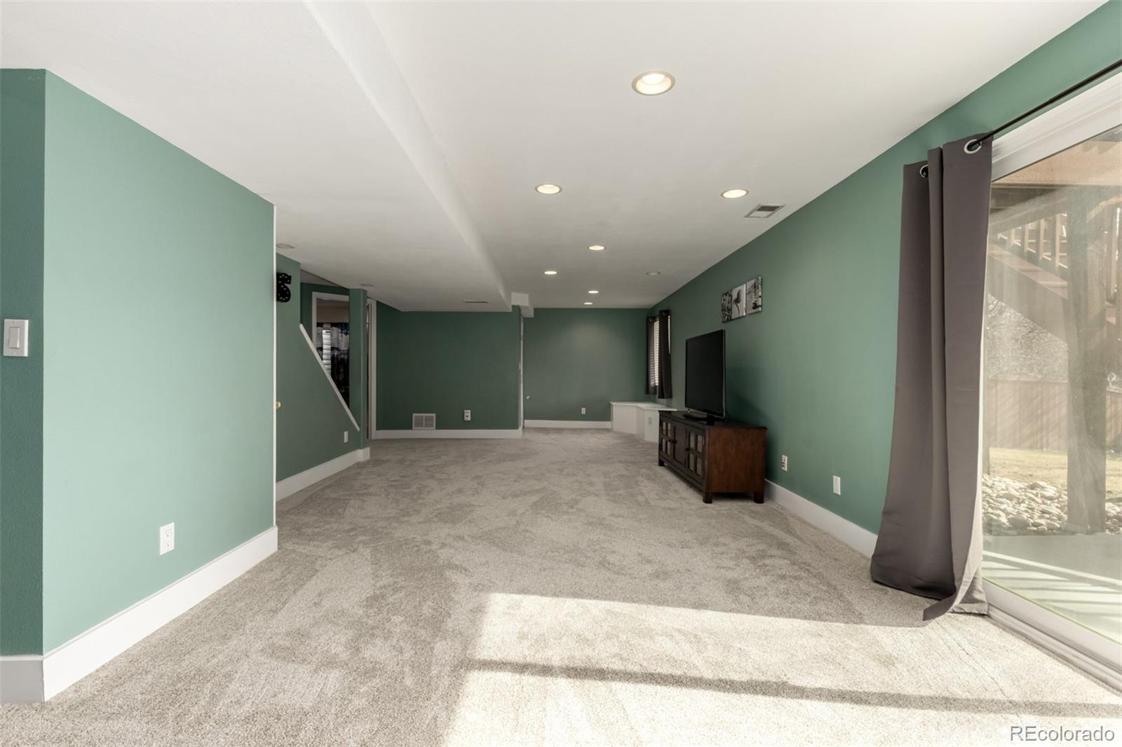 8894 Miners Street Highlands Ranch, CO 80126 - Photo 30 of 41 a view of a hall with wooden floor and a rug