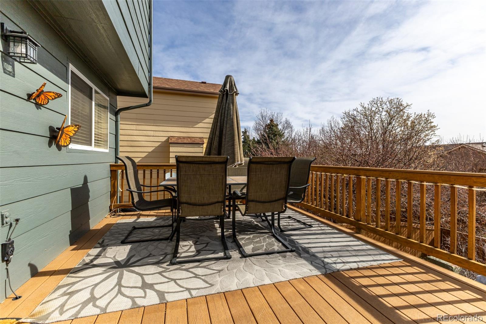 8894 Miners Street Highlands Ranch, CO 80126 - Photo 38 of 41 a view of balcony with wooden floor and outdoor seating
