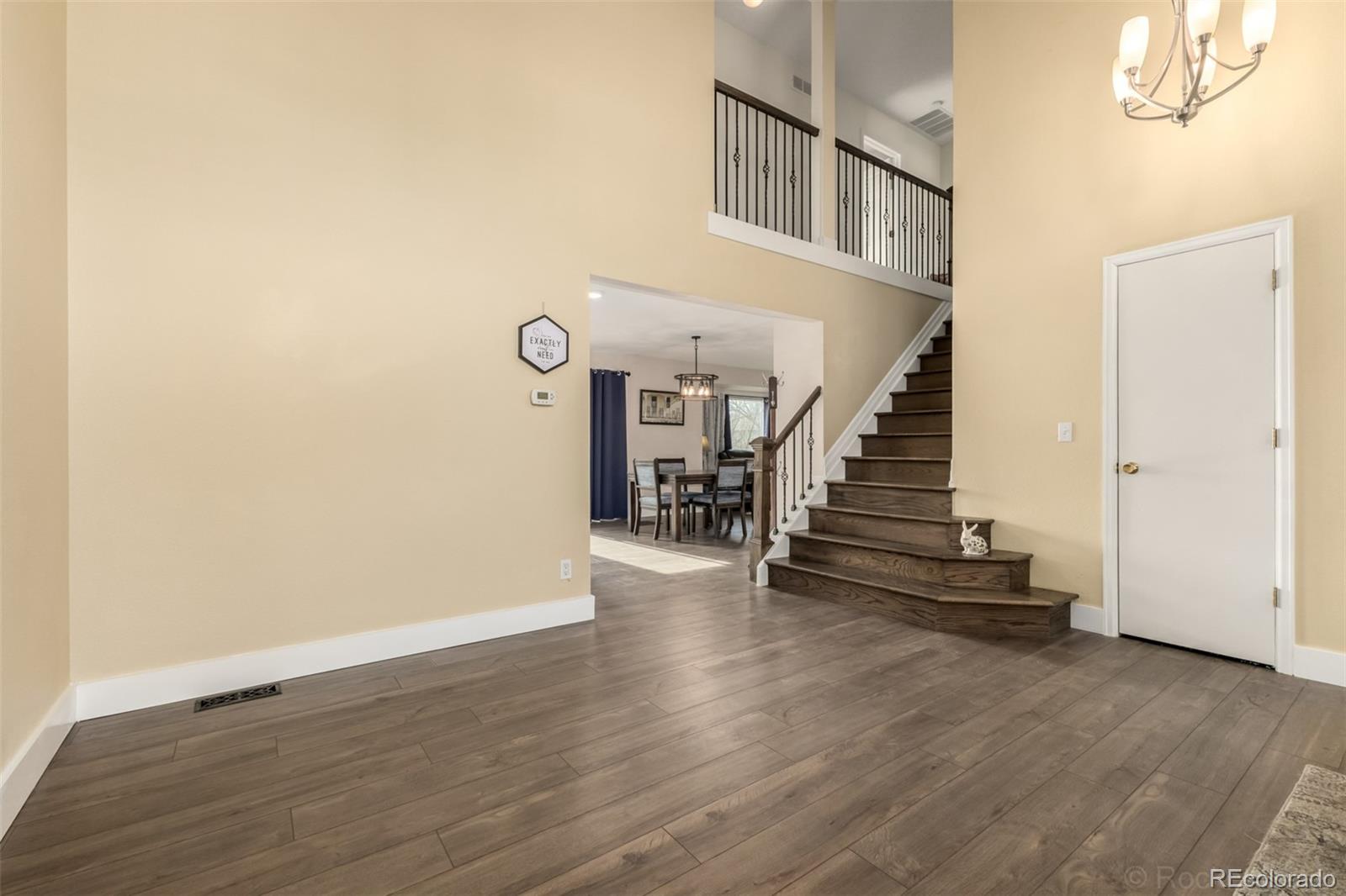 8894 Miners Street Highlands Ranch, CO 80126 - Photo 4 of 41 a view of entryway and hall with wooden floor