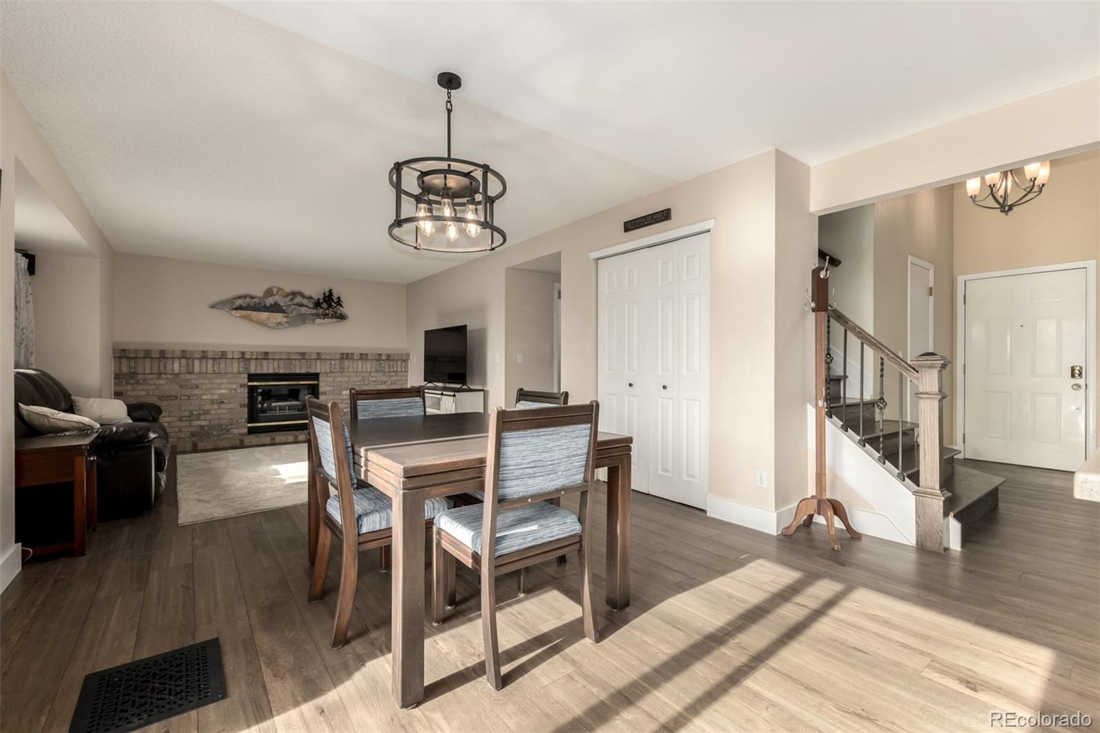 8894 Miners Street Highlands Ranch, CO 80126 - Photo 9 of 41 a view of a dining room with furniture wooden floor and chandelier