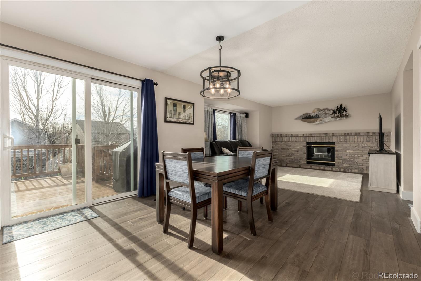 8894 Miners Street Highlands Ranch, CO 80126 - Photo 10 of 41 a view of a dining room with furniture window and wooden floor