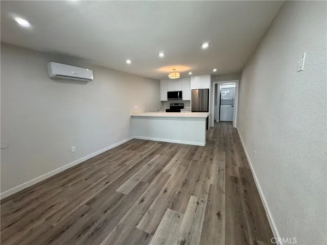 a view of kitchen with sink and wooden floor