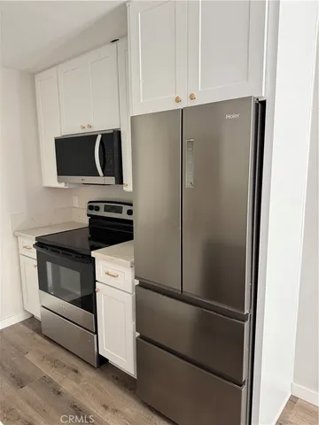 a white refrigerator freezer and a stove sitting inside of a kitchen