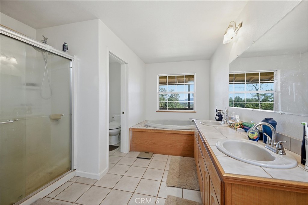 16965 Spruce Grove Road Hidden Valley Lake, CA 95467 - Photo 14 of 34 a spacious bathroom with a tub sink and window