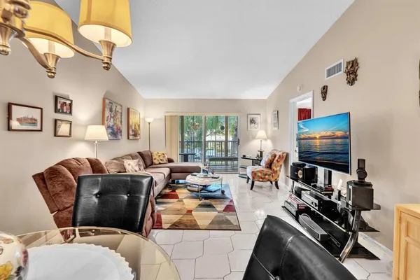 a living room with furniture flowerpot and a window