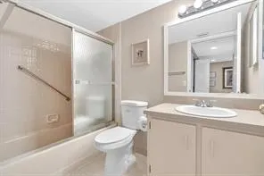 a view of a room that has a bed and wooden floor