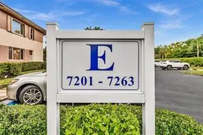 an aerial view of a city with lots of residential buildings and mountain view in back