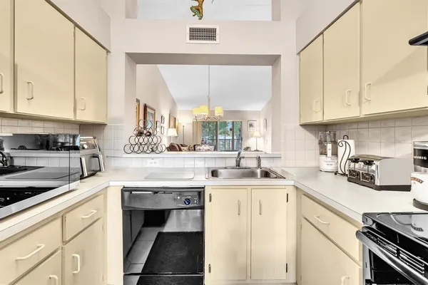 a kitchen with a sink cabinets and window
