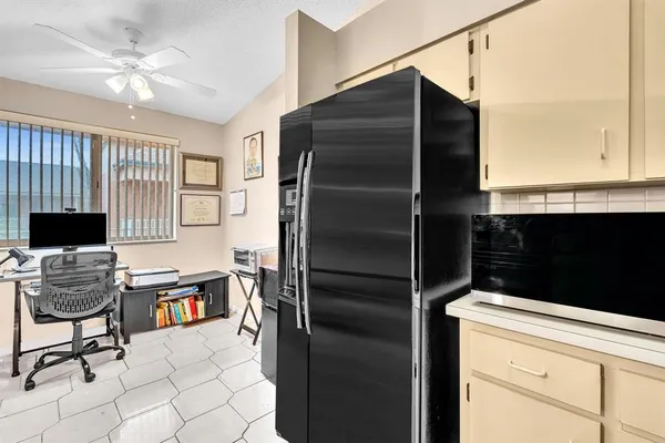 a kitchen with stainless steel appliances granite countertop a refrigerator and a stove
