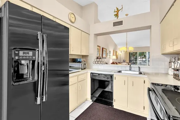 a kitchen with a sink cabinets and stainless steel appliances