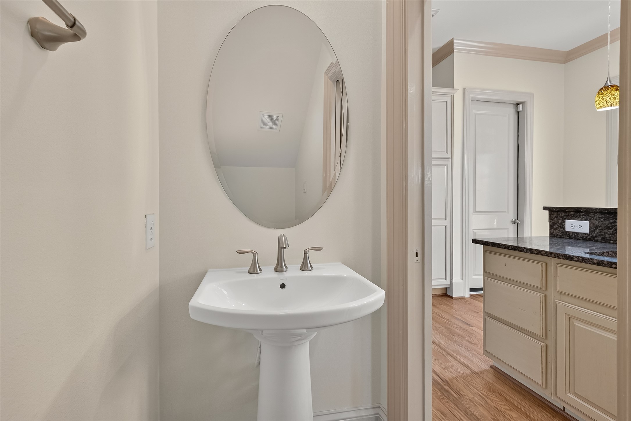 931 West 23rd Street, Unit K Houston, TX 77008 - Photo 13 of 40 Powder room on 1st floor is 6'11" x 3'4" has pedestal sink, brushed nickel faucet, glass block window, vanity light and sliding pocket door.