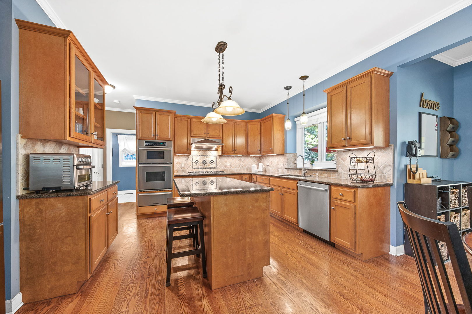 2816 Cordgrass Road Naperville, IL 60564 - Photo 8 of 49 a kitchen with stainless steel appliances granite countertop wooden floors stove top oven and refrigerator
