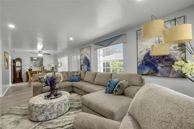 a living room with furniture and a large window