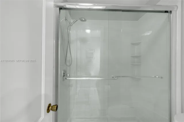 a bathroom with a glass shower door