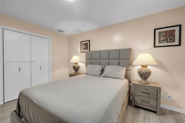 a bedroom with a bed and lamp