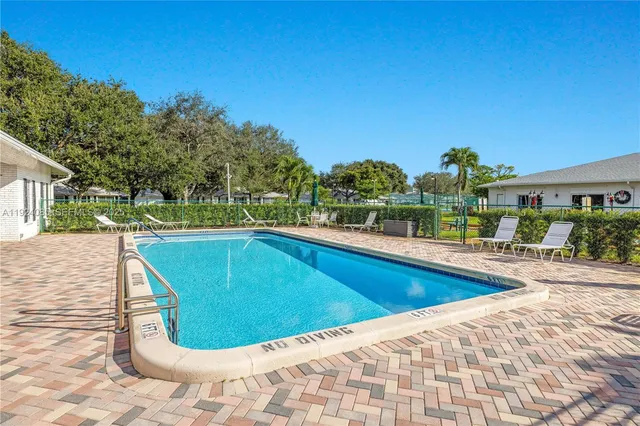 a view of a swimming pool with a patio