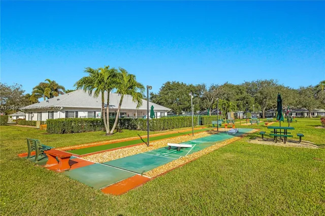 a view of a house with swimming pool and yard