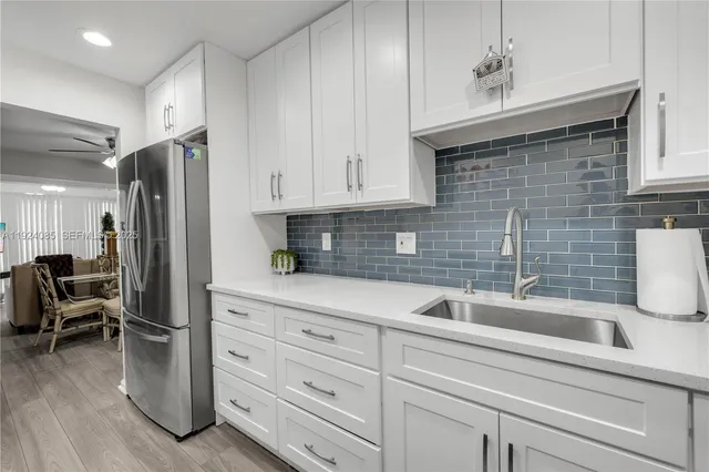 a kitchen with stainless steel appliances white cabinets and a sink