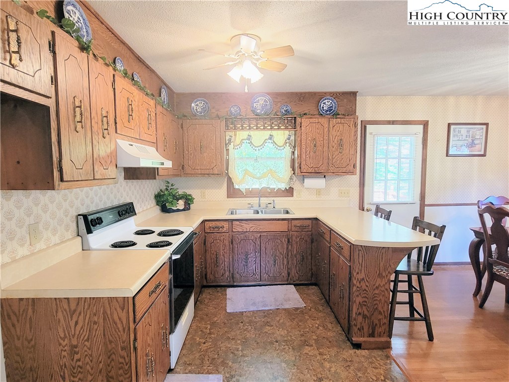 246 Jake Blackburn Road Lansing, NC 28643 - Photo 3 of 20 a kitchen with stainless steel appliances granite countertop a sink stove and refrigerator
