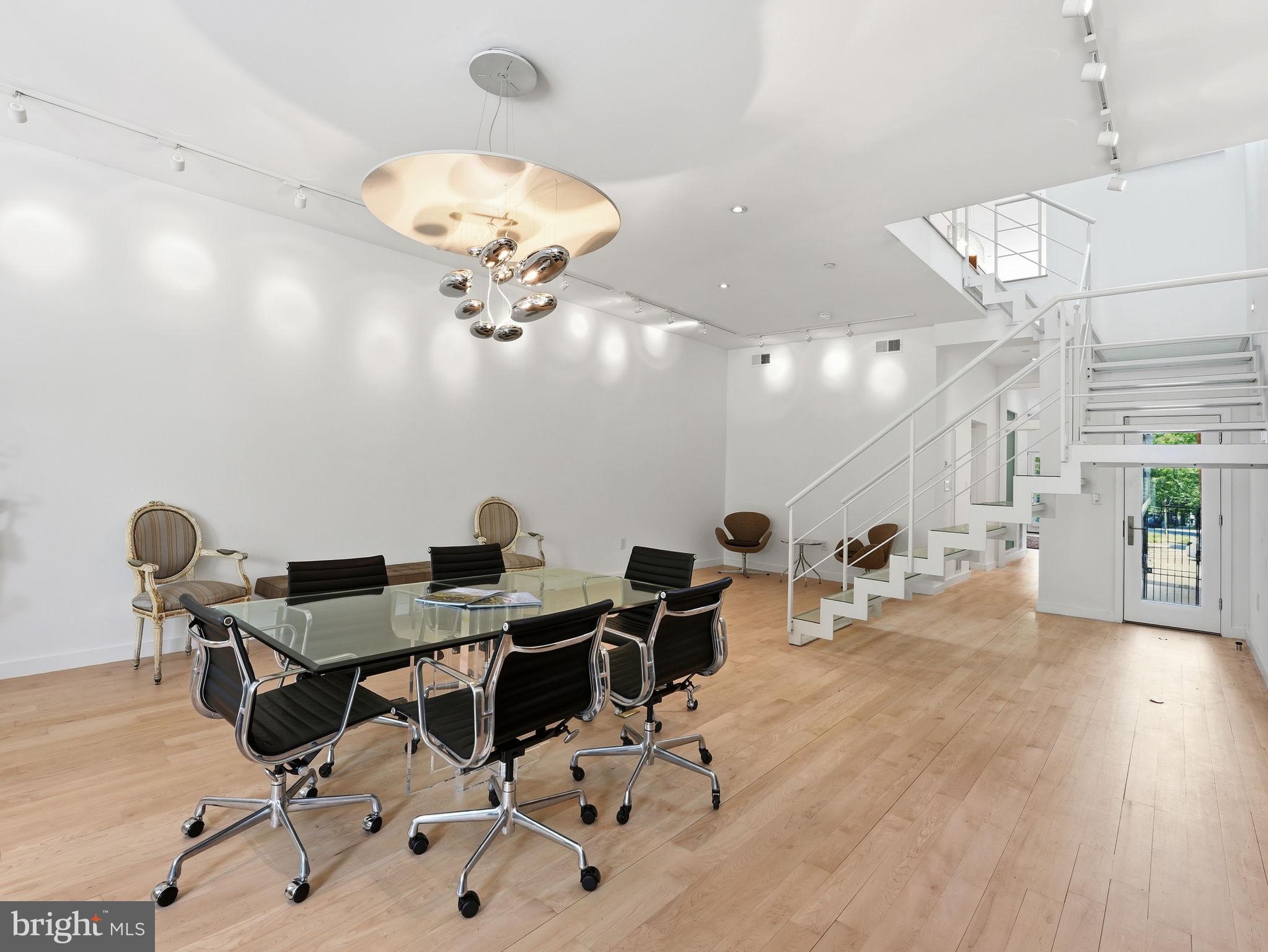 1845 Calvert Street Northwest Washington, DC 20009 - Photo 35 of 48 a view of a workspace with furniture and a chandelier