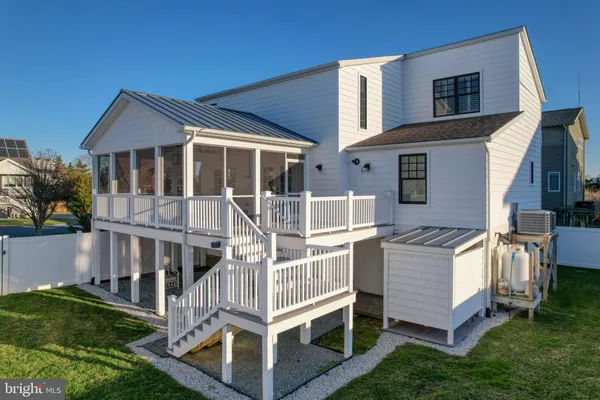 a bedroom with a bed and a lamp on dresser