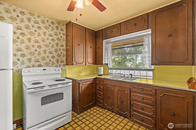 a kitchen with stainless steel appliances a stove a sink and a refrigerator
