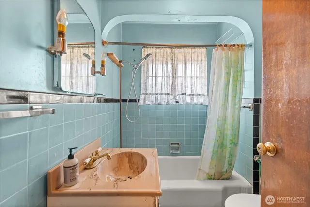 a bathroom with a sink and shower