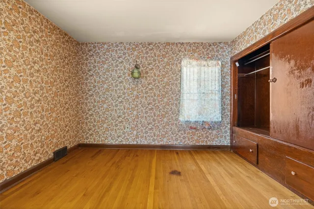 a bathroom with a wooden floor and a shower