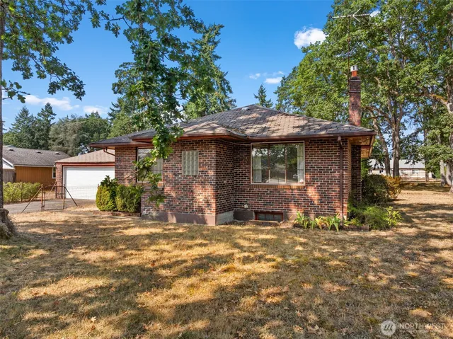 a front view of a house with a garden
